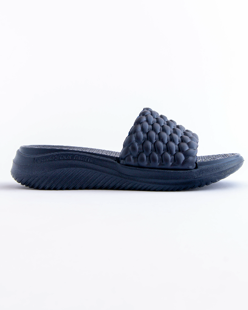 Navy blue slide sandal with textured strap on a white background