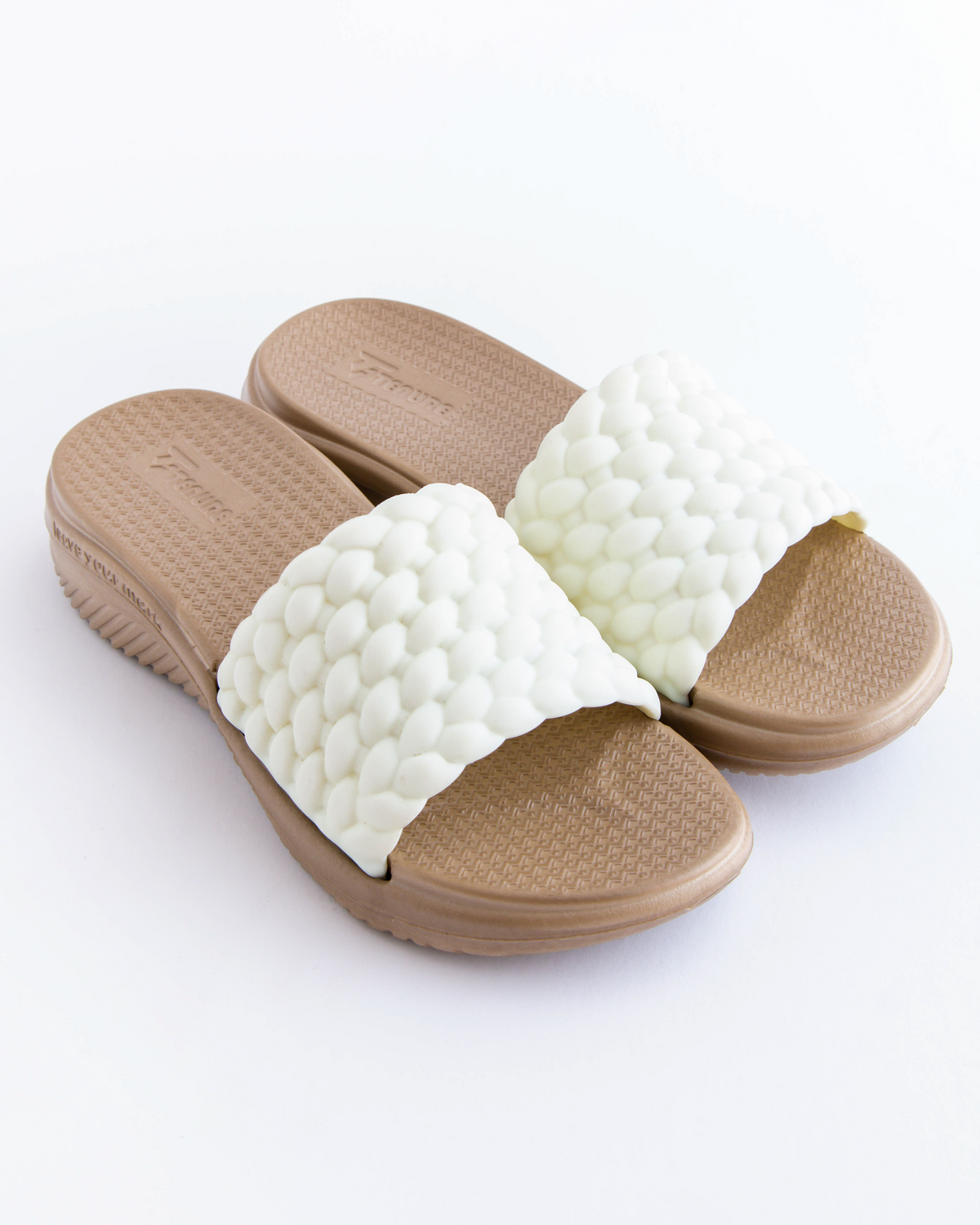 Pair of brown and white slippers on a white background